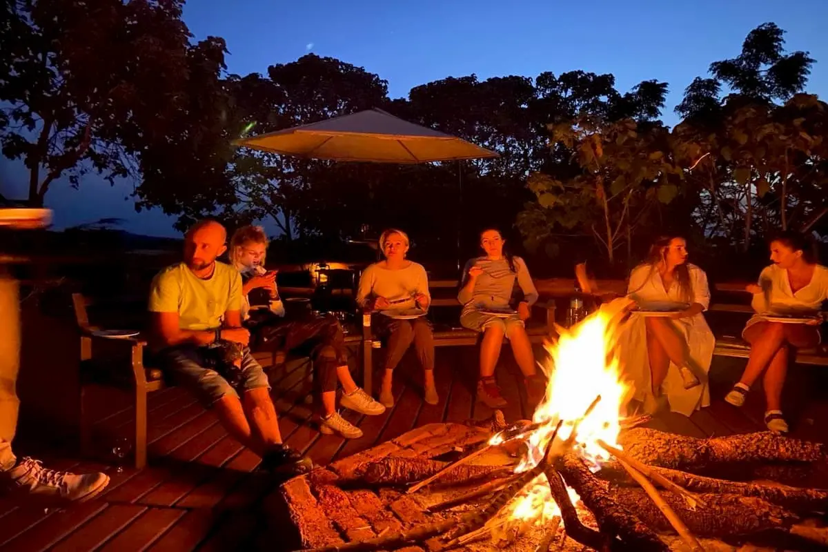 Group of safari-goers around the campfire