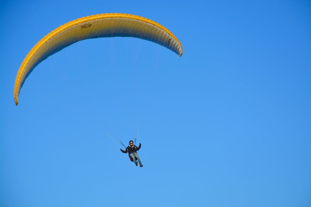 A paraglider pilot in the sky