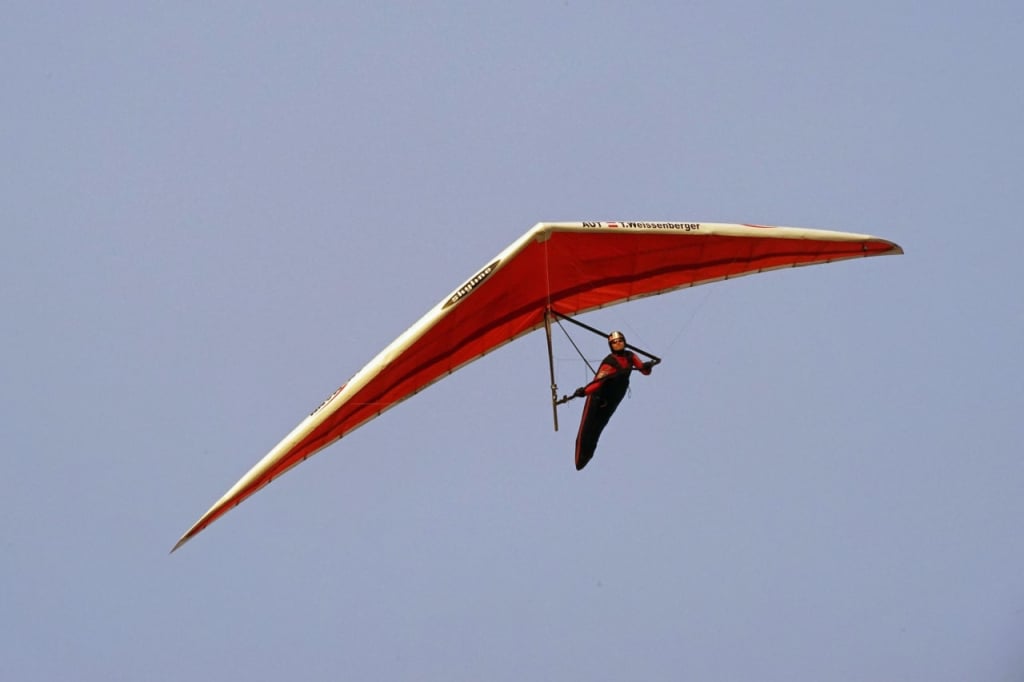 A hang glider pilot in the sky
